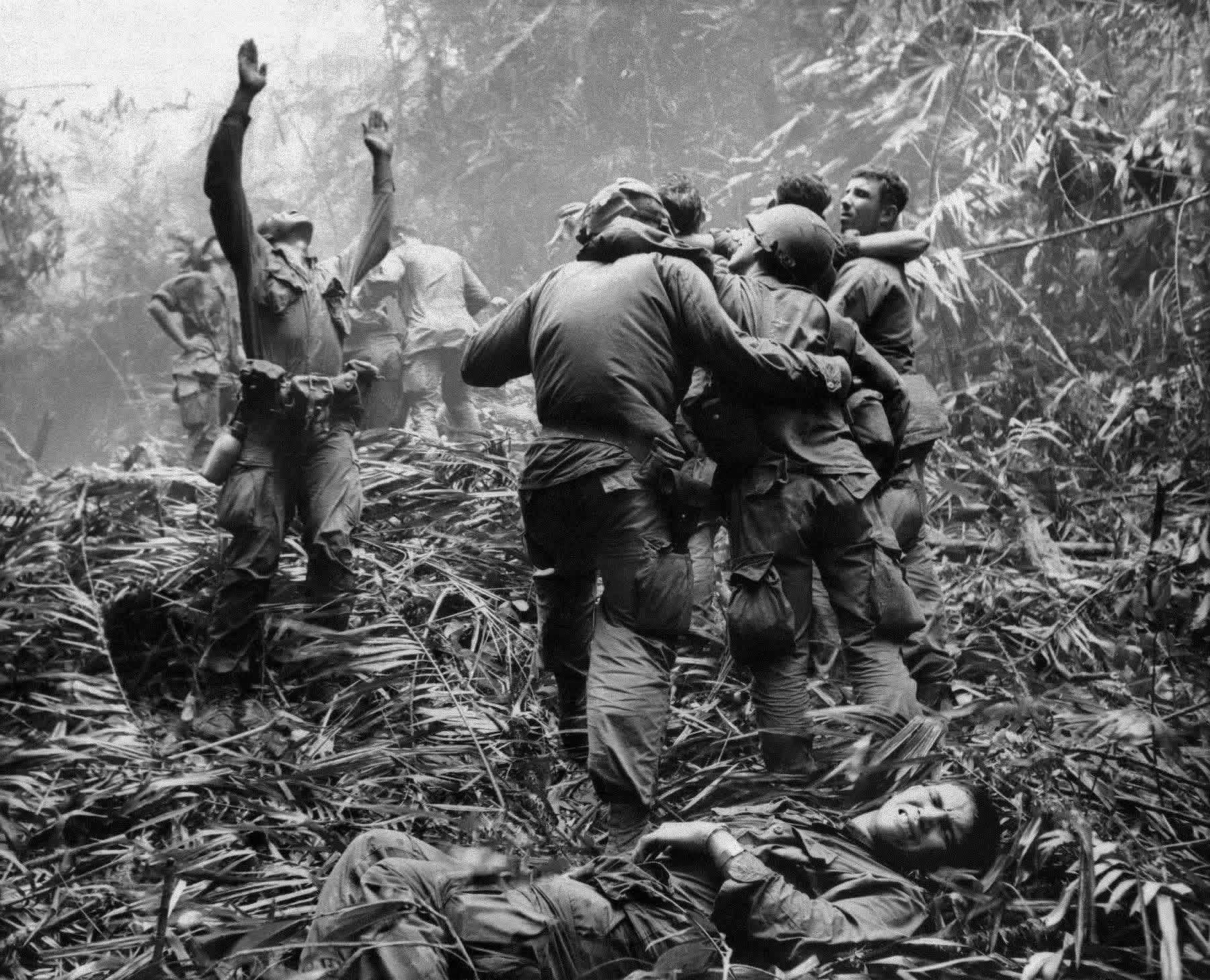 As fellow troopers aid wounded buddies, a paratrooper of A Company, 101st Airborne, guides a medical evacuation helicopter through the jungle foliage to pick up casualties during a five-day patrol of an area southwest of Hue, South Vietnam, April 1968. [1800×1458]