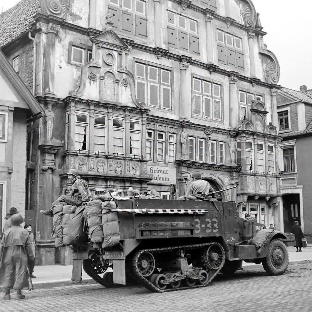M4 Mortar Carrier nicknamed “LUCIA” with HQ Company, 3rd Battalion, 66th Armored Regiment, 2nd Armored Division, in front of the Hexenbürgermeister House in Lemgo, Germany – April 1945 [1080×1080]