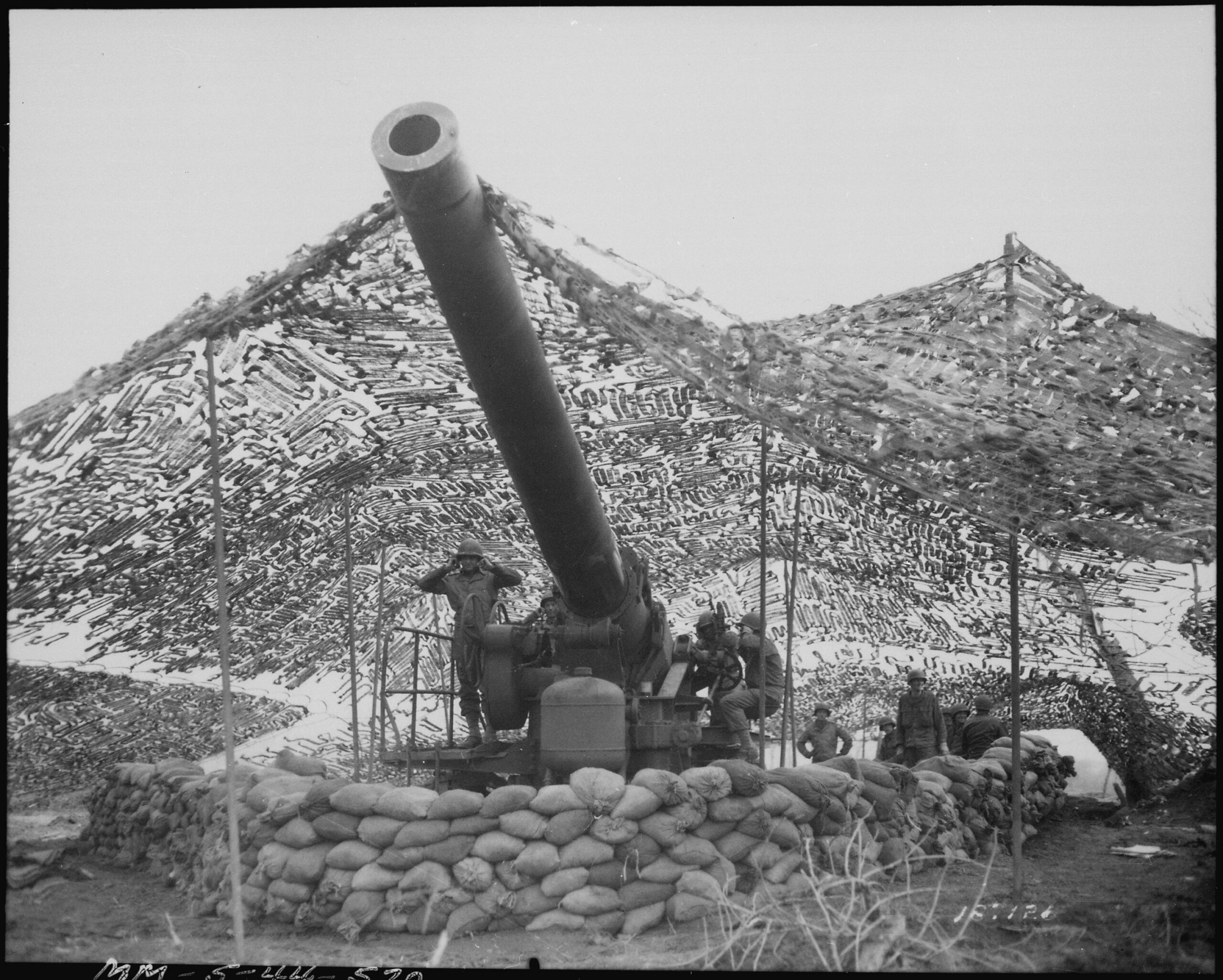 A 240mm Howitzer of Battery B, 697th Field Artillery Battalion, shortly before firing on German positions at Mignano, Italy. January 1944. [3000×2404]
