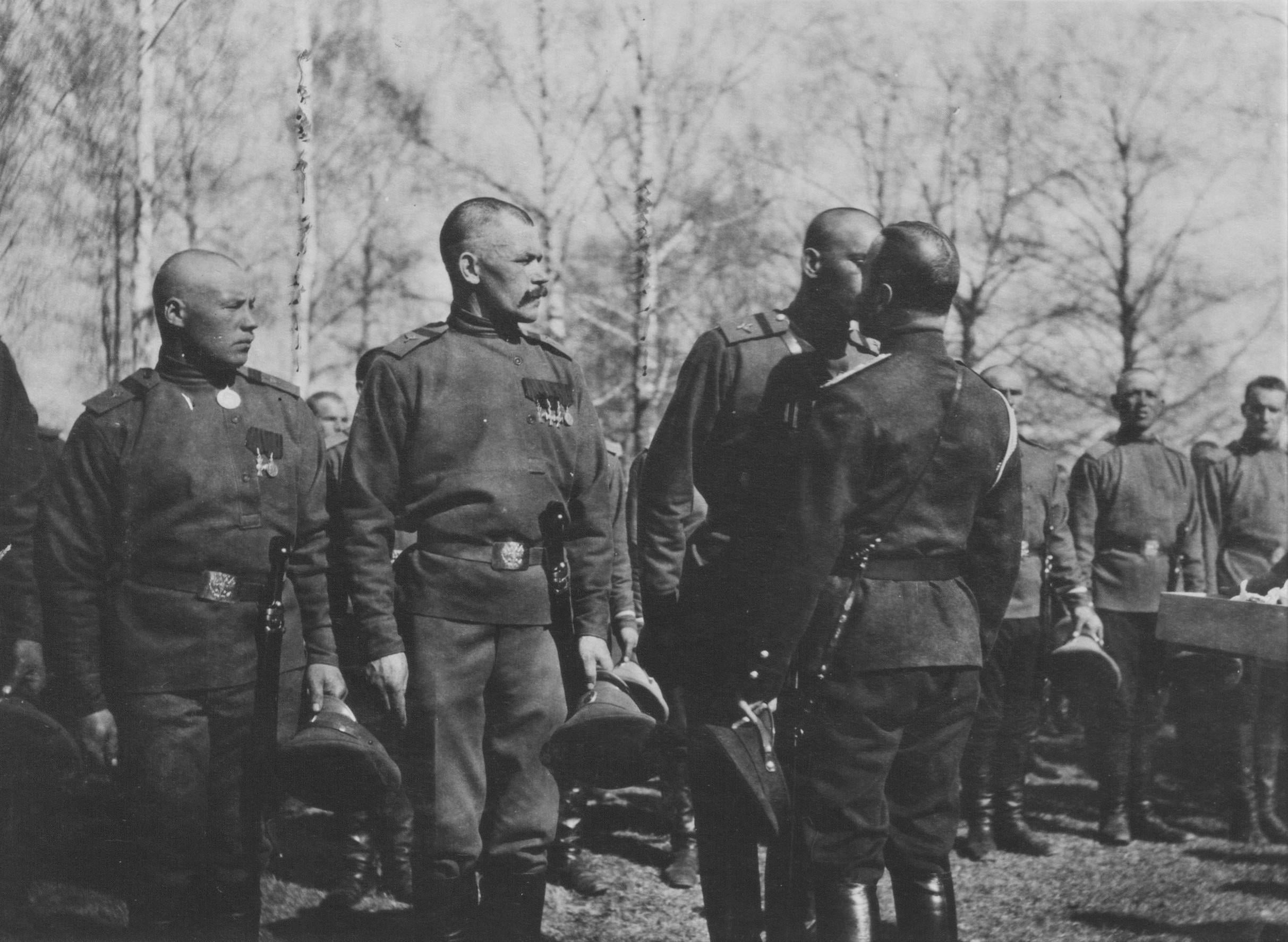 Tsar Nicholas II giving the kiss of holy peace to a Russian soldier during WWI, 1916. The Tsar, his family, and his regime would not survive the next two years (2425×1774)