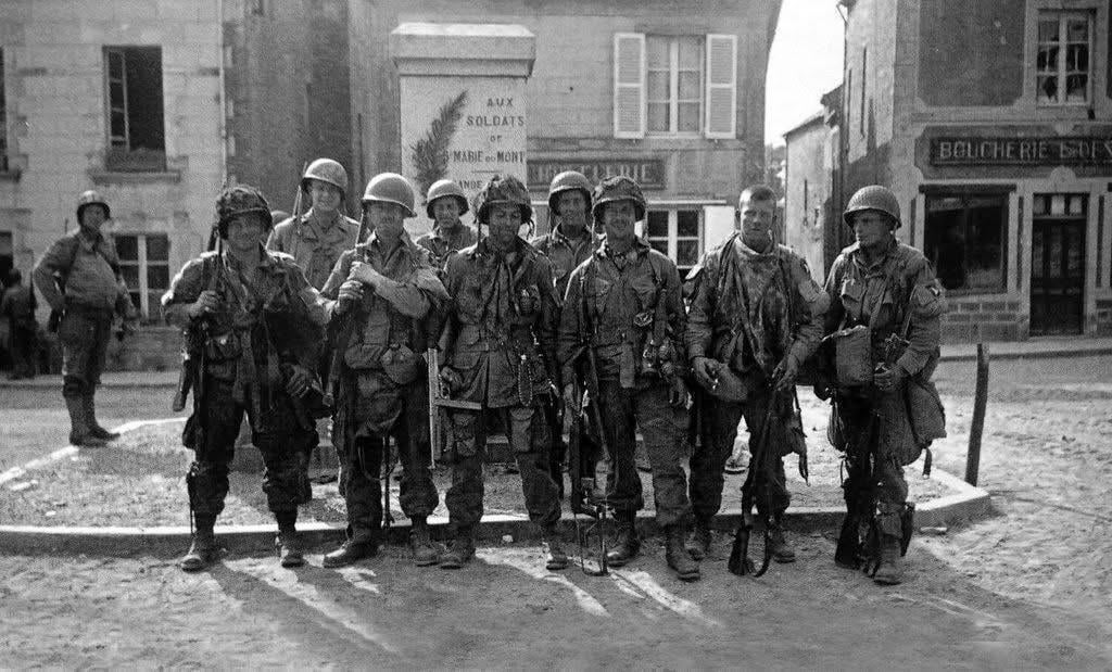 Paratroopers of Easy Company, 506th PIR, “Band of Brothers”, in the square of Sainte-Marie-du-Mont, D+1, 1944. Front, left to right: Forrest Guth, Frank Mellet, David Morris, Daniel West, Floyd Talbert and C.T. Smith. [1024×619]