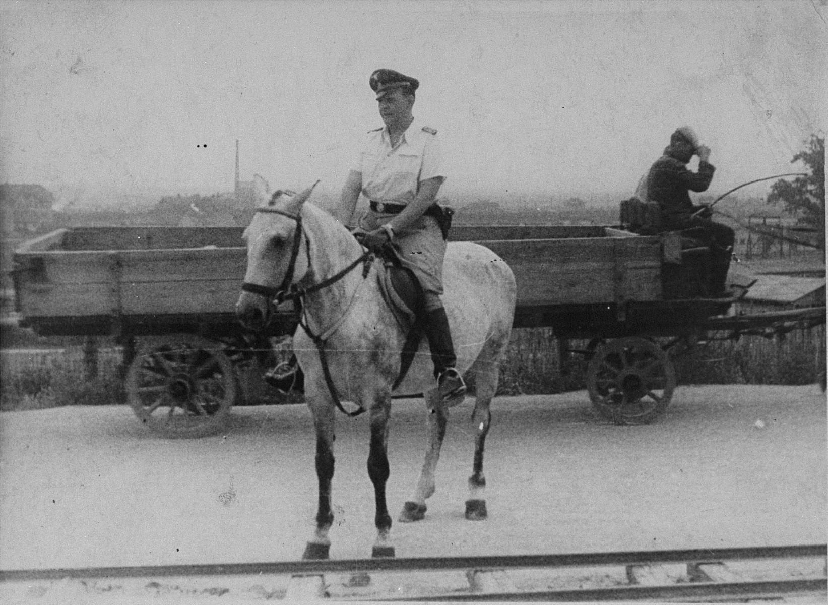 SS commander & Krakow-Plaszow concentration camp director Amon Göth surveying the site on horseback, between 1943-44. Göth became notorious for his extreme abuses of power while serving as director, such as periodically shooting random prisoners from the balcony of his room with a sniper (1643×1200)