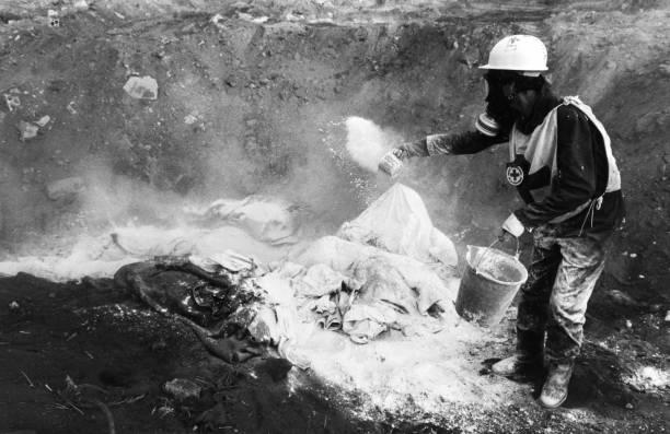 Burial of the bodies of Palestinian refugees victims of the Sabra and Shatila massacre by the Red Cross, Beirut, September 1982.[397 x 612]