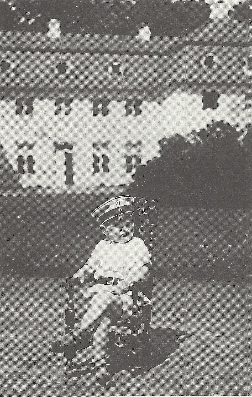 Prussian nobleman’s son Alexander zu Dohna-Schlobitten, 7, sits in a chair at his family’s estate (German Empire, 1907) [652 x 1024].