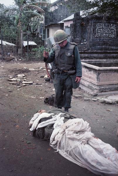 Maj. Aloysius S. McGonigal, a Catholic chaplain, administered last rites to a dying US Marine during the battle of Hue, February 1968. Photographed by John Olson. [403 × 600]