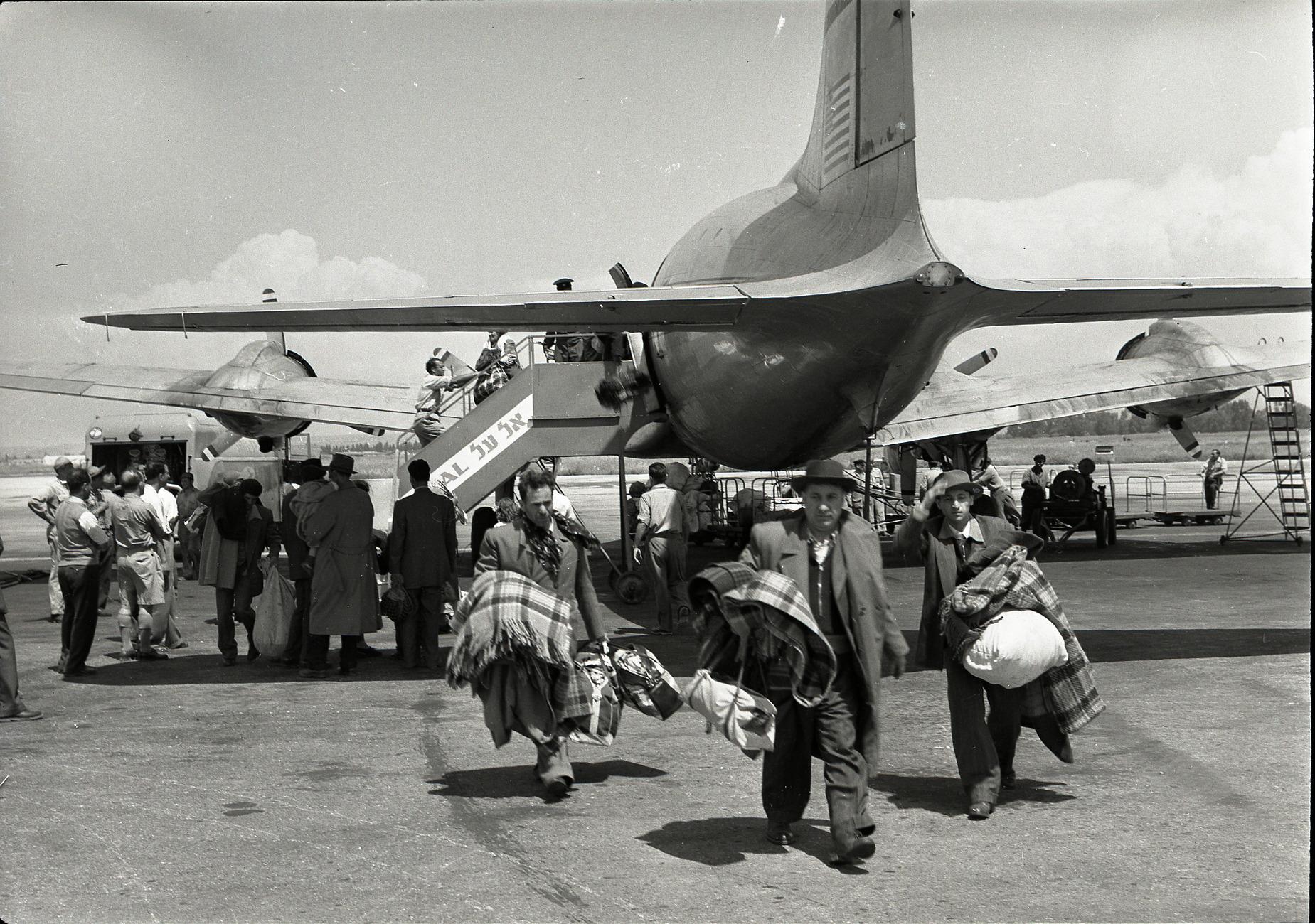 Jewish immigrants from Iraq disembarking a plane at Lod Airport (now Ben Gurion Airport) during Operation Ezra and Nehemiah, the 1950-1952 airlift that brought over 120,000 Iraqi Jews to the newly established state of Israel. (1951) [1849×1300]