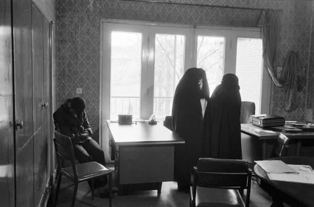 A woman who is a volunteer to marry a veteran of the Iran-Iraq war is introduced to Bahman, who lost both eyes and limbs having stepped on a land mine during the eight year long war. A woman from the Tehran based marriage bureau (R), gives an initial briefing to the candidate, Feb 1st 1986(612×403)