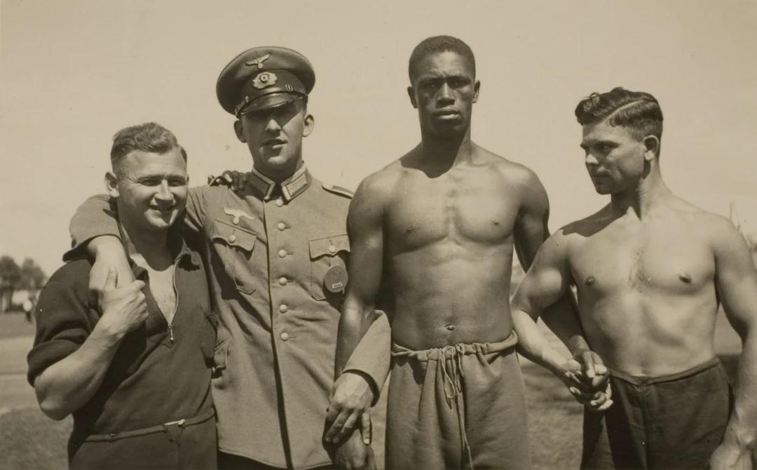 German officers posing with athletes from the American and Indian teams at the Berlin Olympic games, 1936. [1080×670]