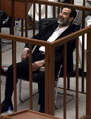 Former president of Iraq. Saddam Hussein laughs at the court in 2006[322×420].