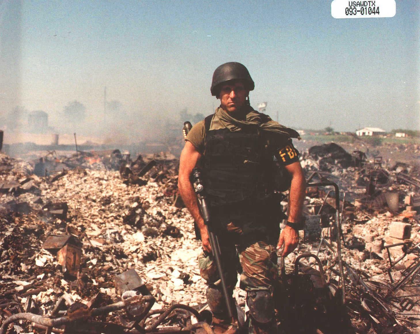 An FBI agent poses among the smoldering ruins of the Mount Carmel compound near Waco on April 19, 1993, where 76 Branch Davidians were killed[1458X1161].