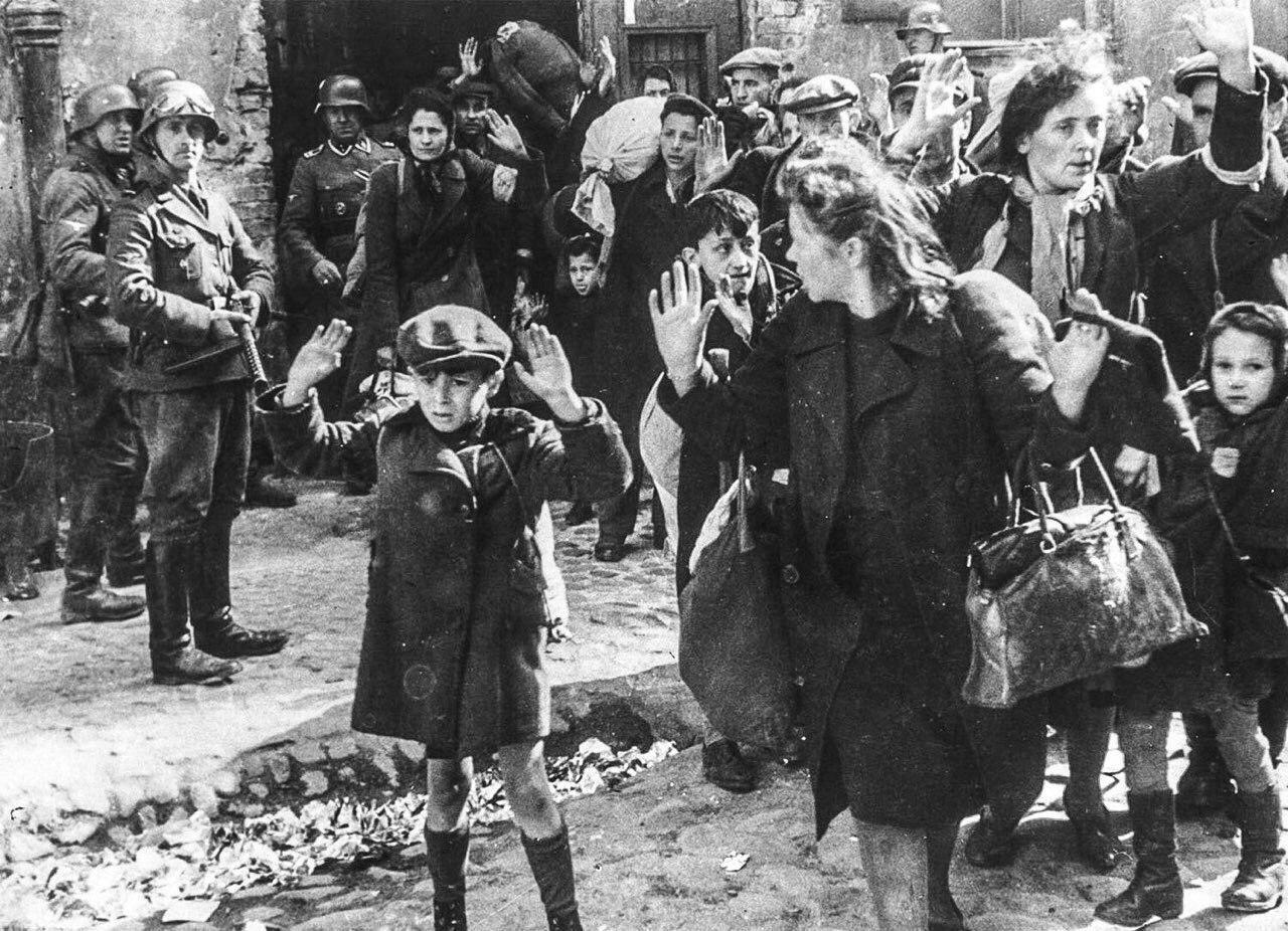 German soldiers escort a group of Jews, including small children, into the Warsaw Ghetto, 1943. [1280×926]