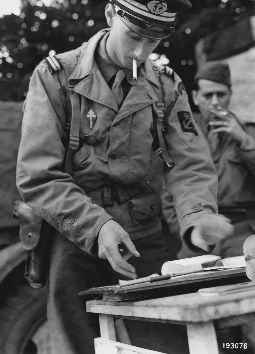 Phillipe De Gaulle, son of the leader of Free France, reading the order of the day while serving the 2nd armored division, Normandy, 1944. [864×1200]