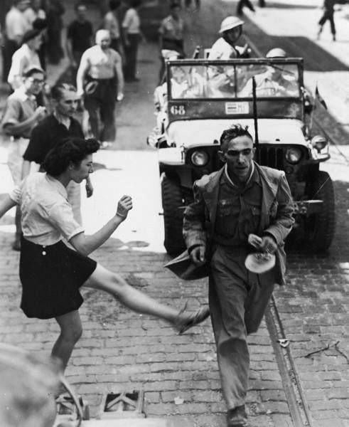 French woman beating a captured German soldier, September 1944. (491×600)