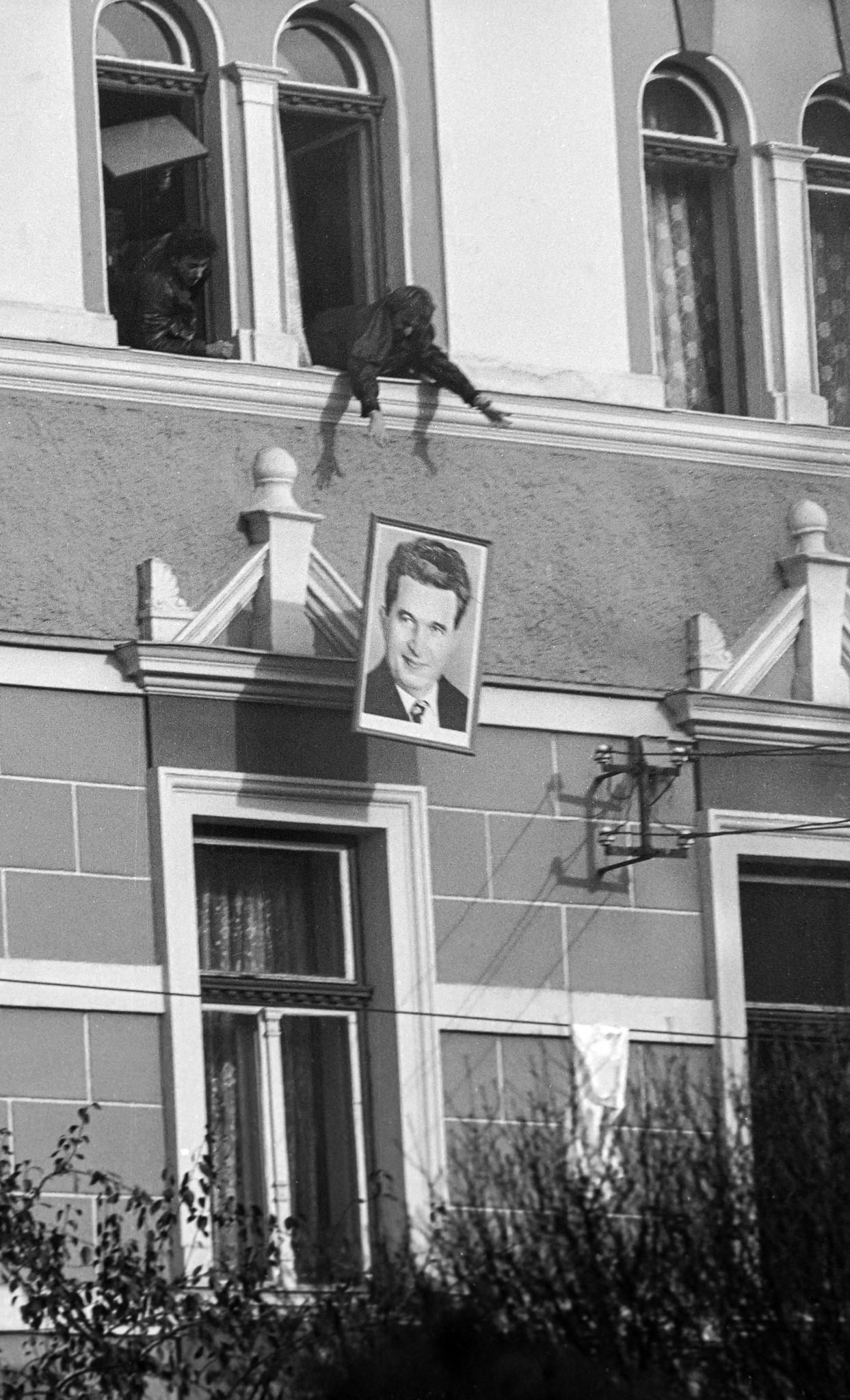A portrait of Nicolae Ceaușescu being thrown out of a town hall window during the Romanian Revolution. Odorheiu Secuiesc, Romania (December 1989) [1243×2048].