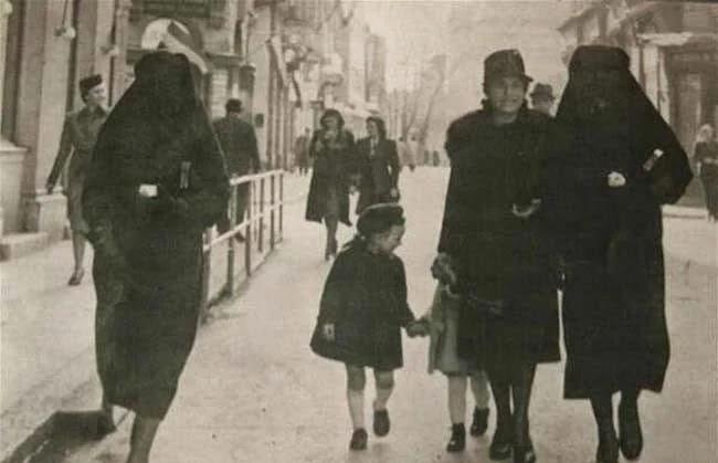 A Muslim woman covers the yellow star of her Jewish neighbor with her veil to protect her from prosecution. Sarajevo, former Yugoslavia, 1941. [650×419]