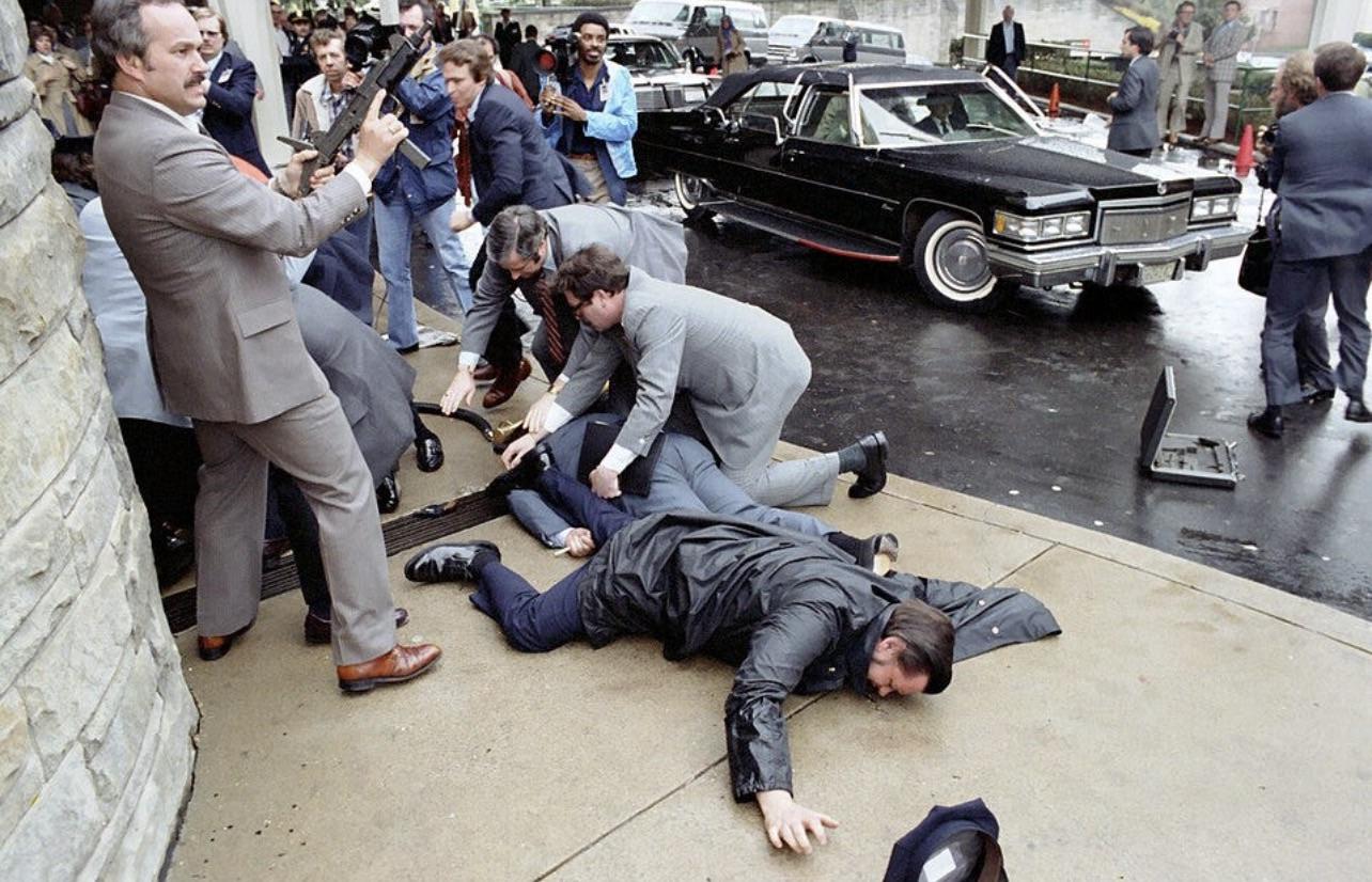 The immediate aftermath of the attempted assassination of President Ronald Reagan, March 30, 1981. Secret Service agents shield Press Secretary James Brady, shot in the head, while Officer Thomas Delahanty lies wounded[1284X826].