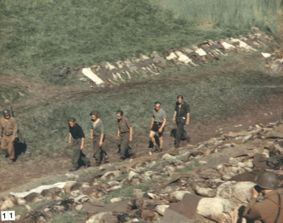 Five SS men are forced to walk past the corpses of prisoners exhumed from a mass grave near Nammering. They’d changed into civilian clothes in a failed attempt to evade capture. According to the photographer, the five men were all shot after this photo was taken (Germany, May 6, 1945) [1170 x 924].