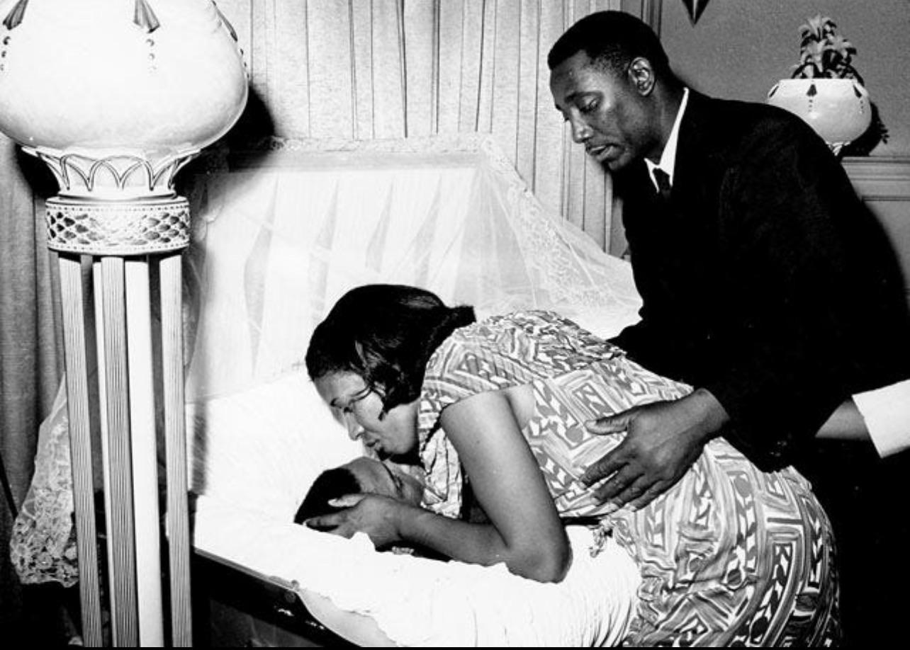 June 13, 1963: Myrlie Louise Evers kisses the forehead of her husband, civil rights activist Medgar Evers, after his assassination. His white supremacist killer would evade conviction for 31 years[1284X918].