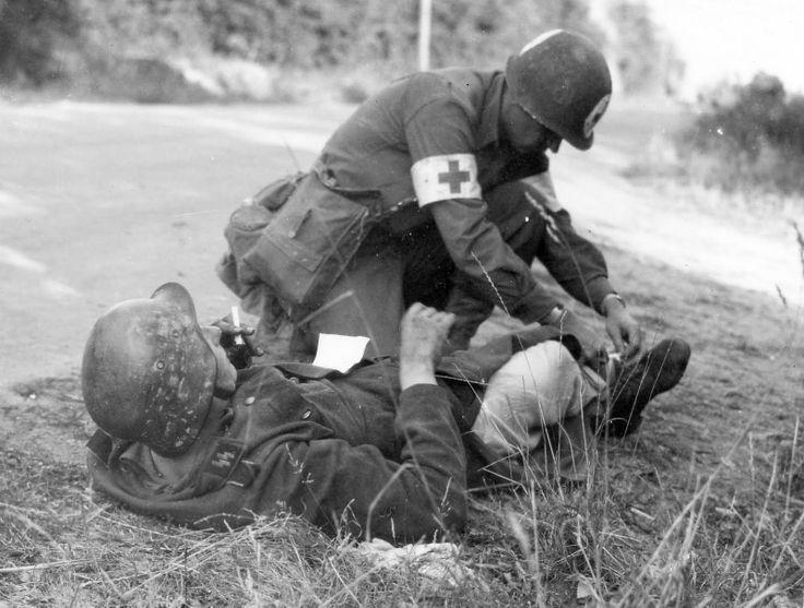 US medic gives first aid to a wounded German SS soldier, France 1944 [736×557]