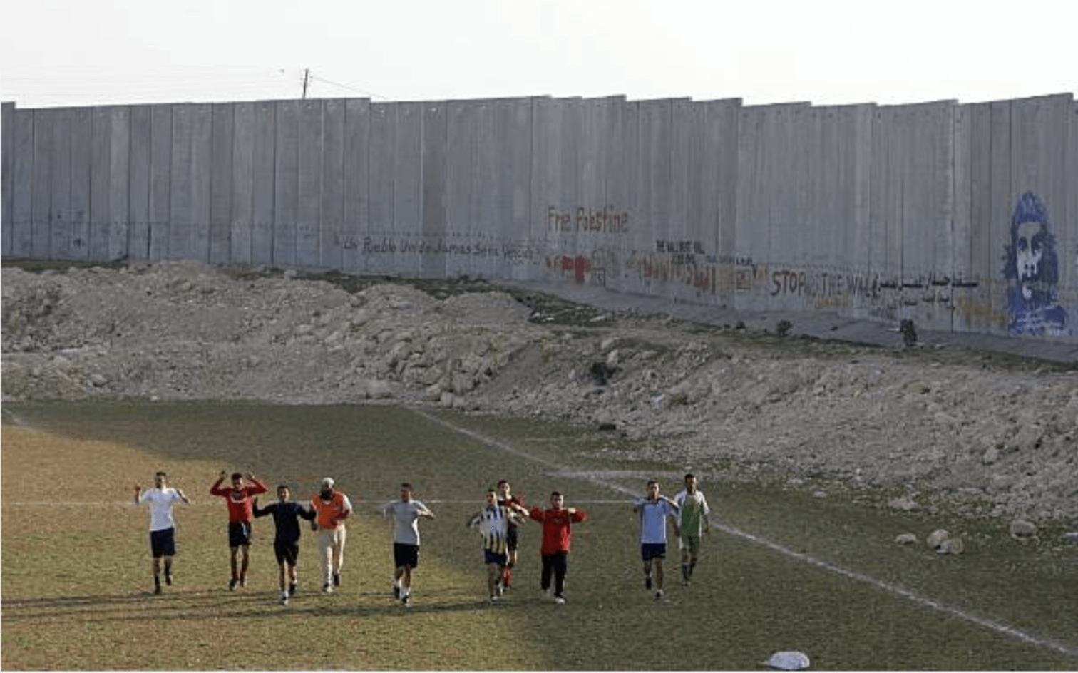 20 years ago today, March 24, 2006. The Abu Dis Palestinian soccer league practices in the Al Quds University soccer field next to the Israeli separation wall in Abu Dis, West Bank. [1512 x 944]