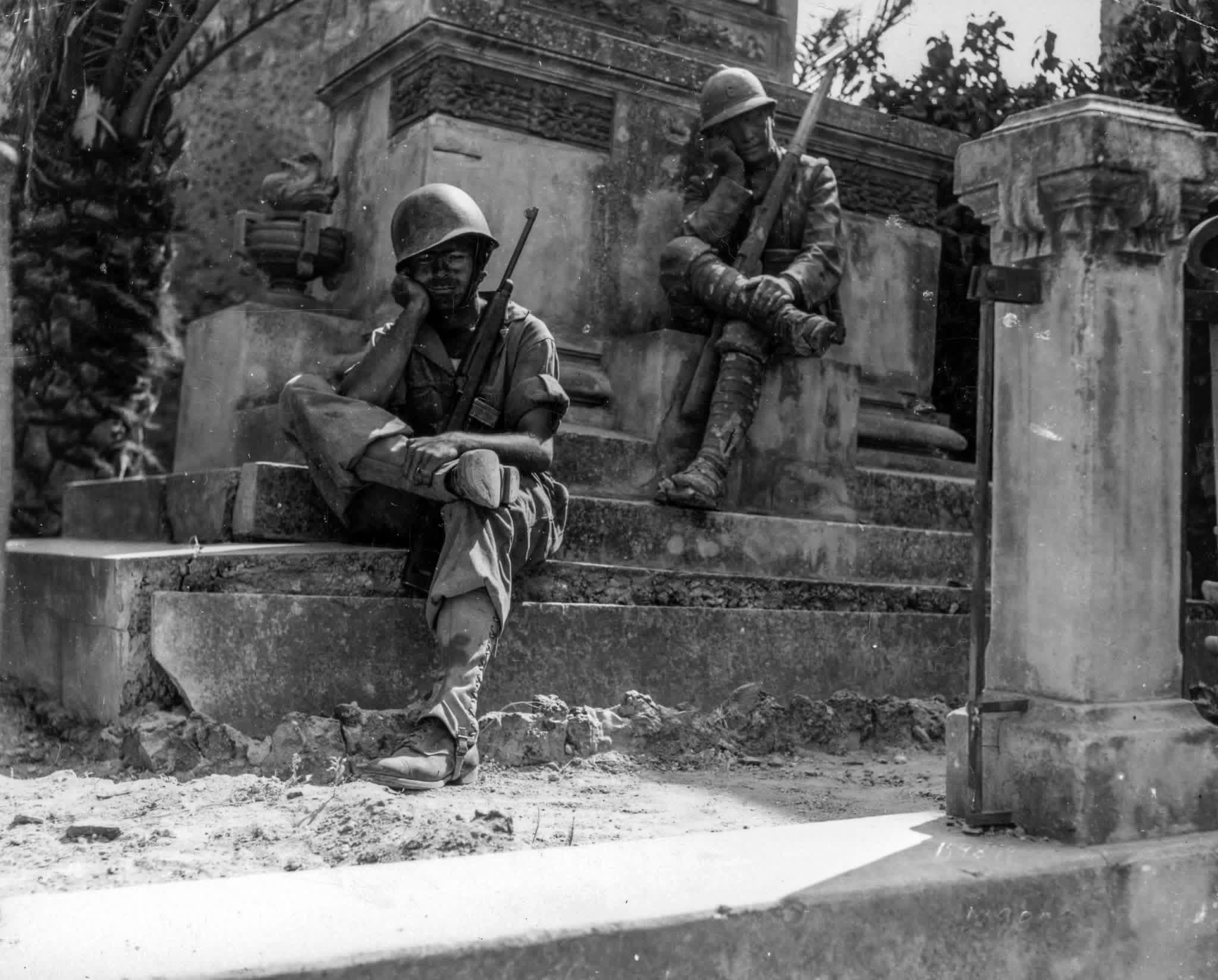 Sgt. Norwood Dorman of Benson, N.C., and the 36th Field Artillery Regiment stops to rest at a memorial to the Italian soldiers of World War I. Brolo, Sicily, Italy. 14 August, 1943. [2048×1648]