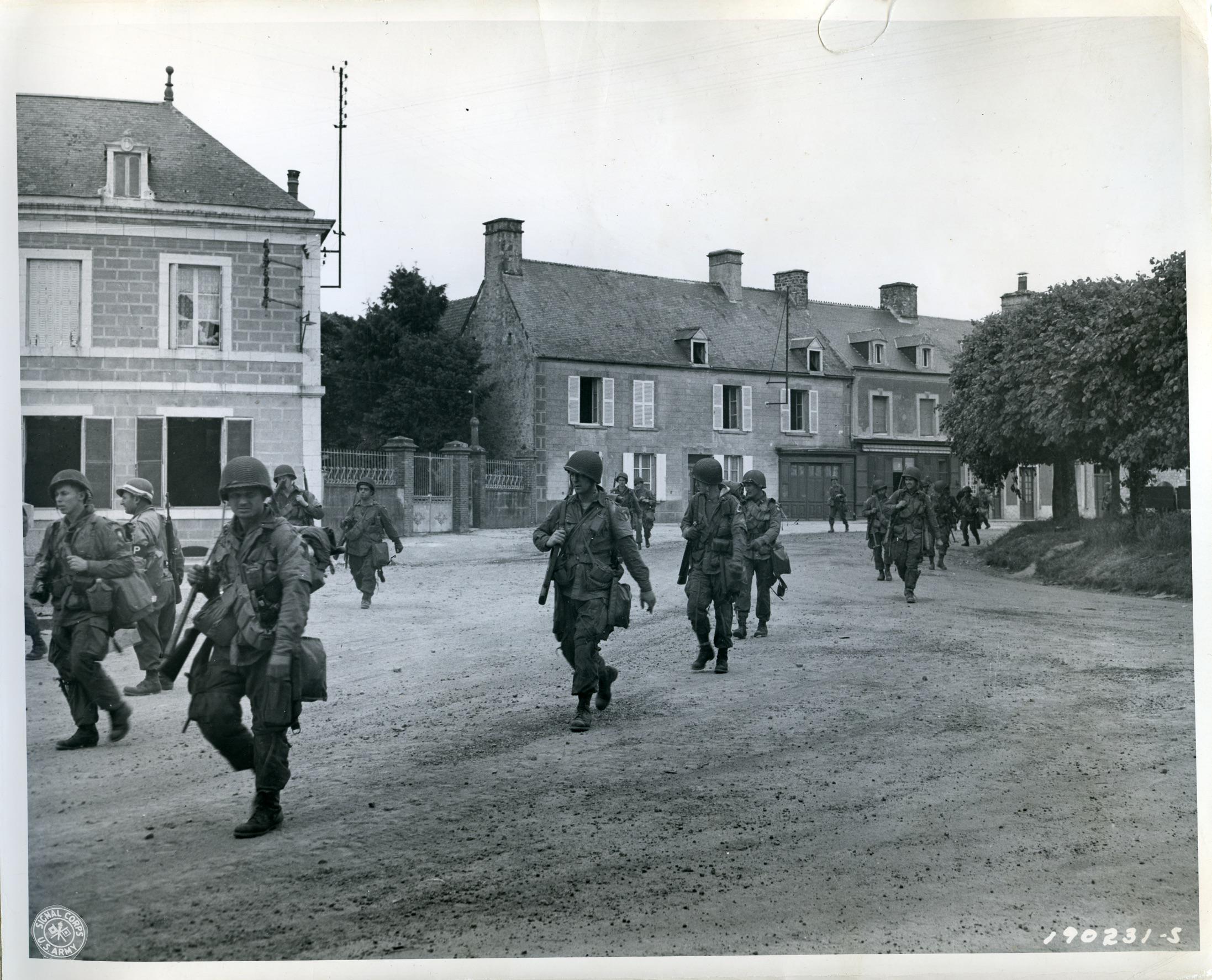 Normandy Invasion – American airborne infantrymen pass through St. Marie Dumont on their way to contact the enemy. Utah Beach, France (June 7, 1944) [3939×3185]