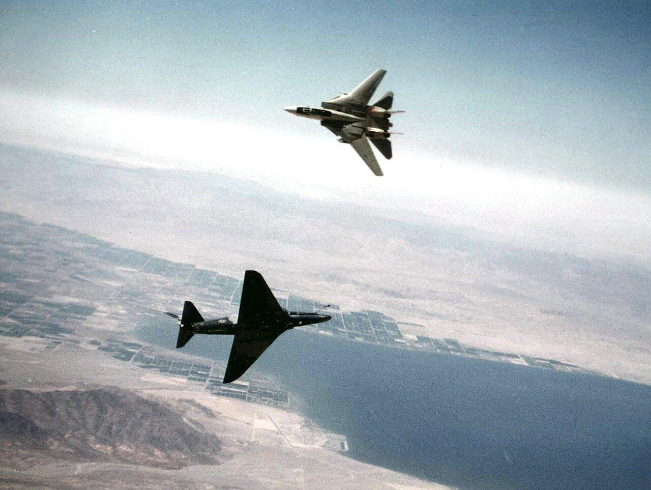U.S Navy Douglas A-4F ‘Skyhawk’ from Fighter Squadron VF-126 “Bandits” and an F-14A ‘Tomcat’ fighter jet of VF-111 ‘Subdowners’ – during training over the northern end of the Salton Sea, c. April 1982. [1280 x 963]