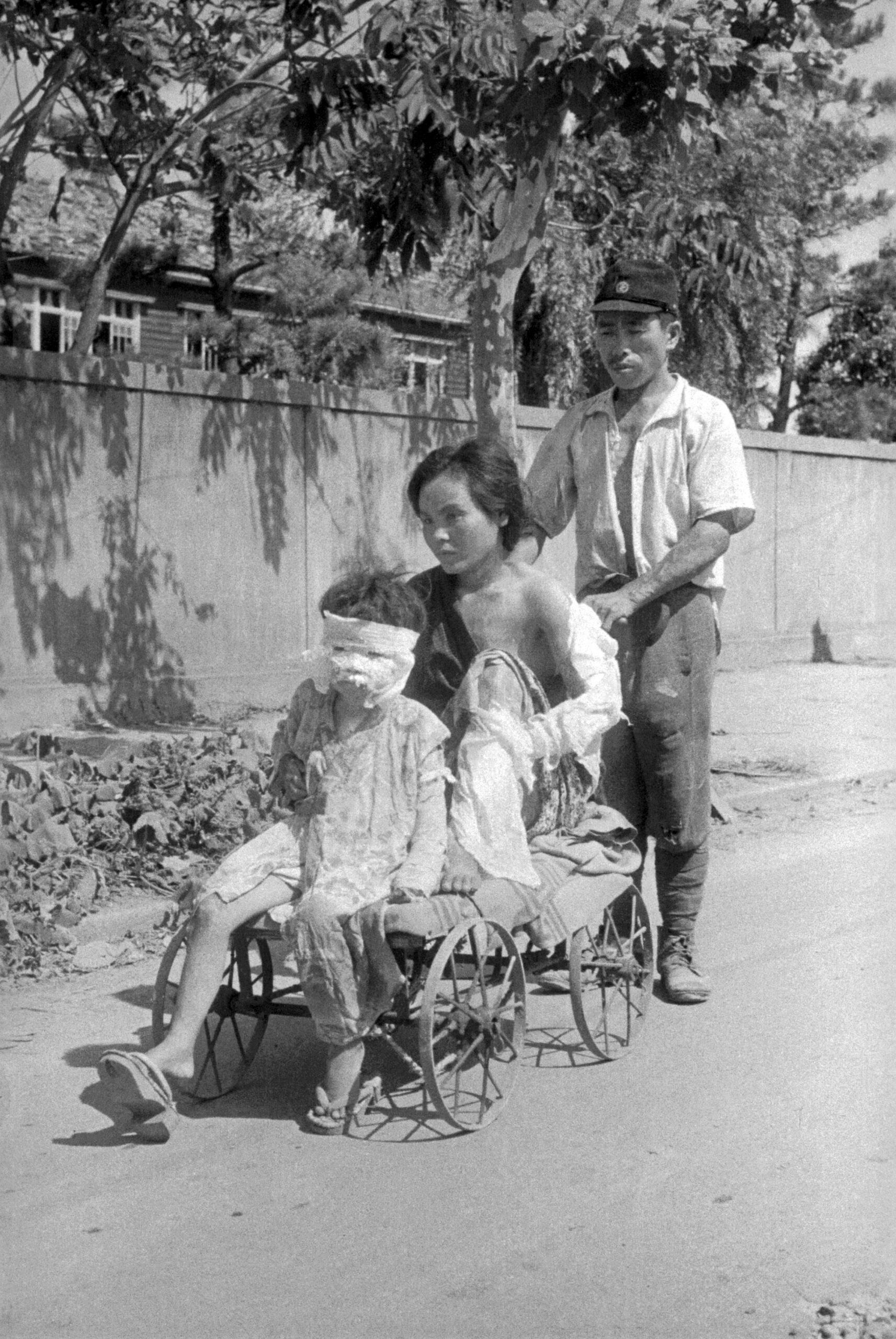 Family going home after treatment, Hiroshima 1945.[1713×2560]