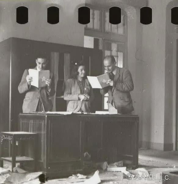 French officials going through the remaining documents at the DRV Tonkin Palace after its capture. 1946.[583×600].