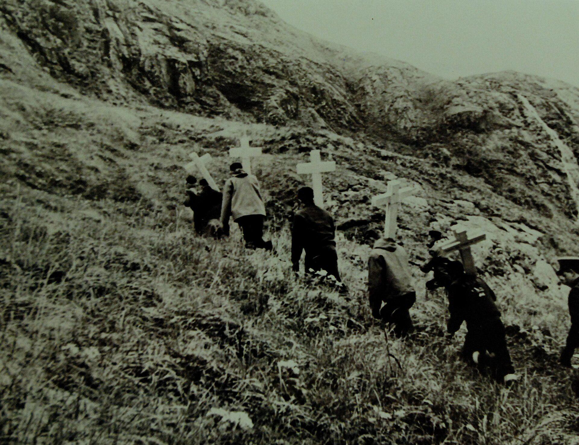 US Navy men hike up a hill bearing crosses to perform the last rites for their fallen comrades during the battle of Attu, May, 1943. [1920 × 1476]