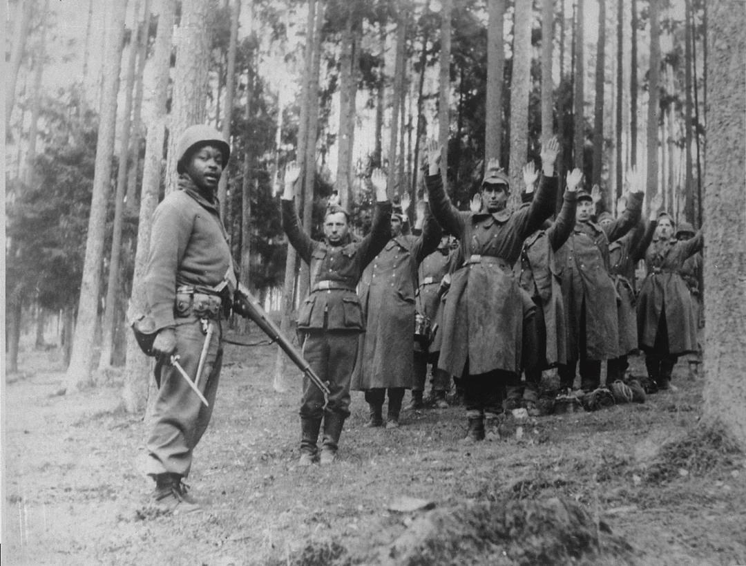 African american 12th Armored Division soldier with captured German prisoners, April of 1945. [1080×819]