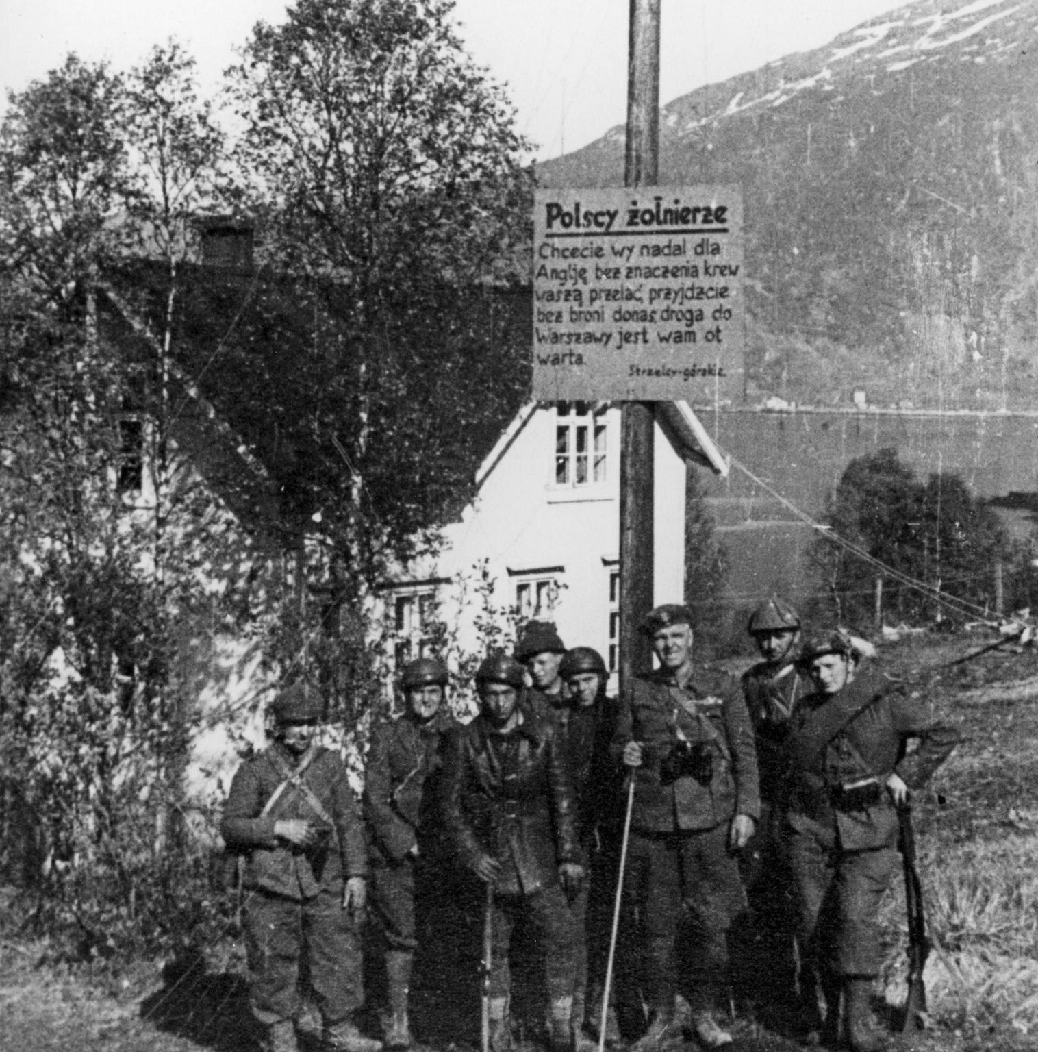 Soldiers of Polish Independent Highland Brigade standing next to a German sign calling them to desert, Norway, 1940. Photo by Czesław Datka. [1516×1536]