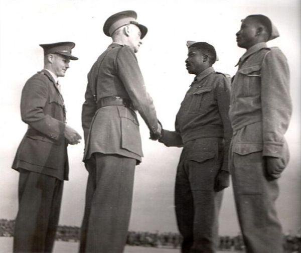 L/Cpl Job Maseko receives his Military Medal (MM) from Major General Theron, after Job had blown up a German vessel with an improvised explosive while in Nazi captivity at Tobruk. 1943 [600×504]