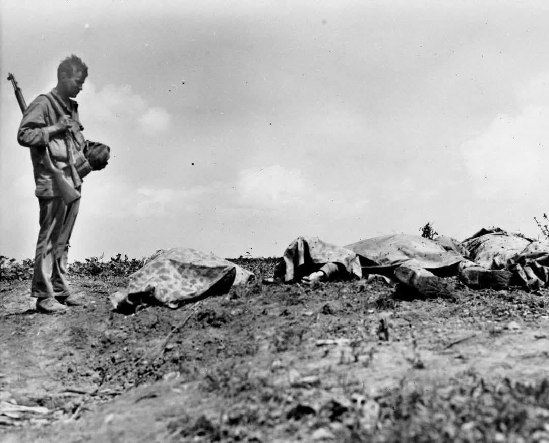Marine PFC George Max Chanak pauses by a row of fallen comrades on Okinawa in May, 1945. George was Killed in Action shortly after this picture was taken. He was only 19 years old. [1080×871]