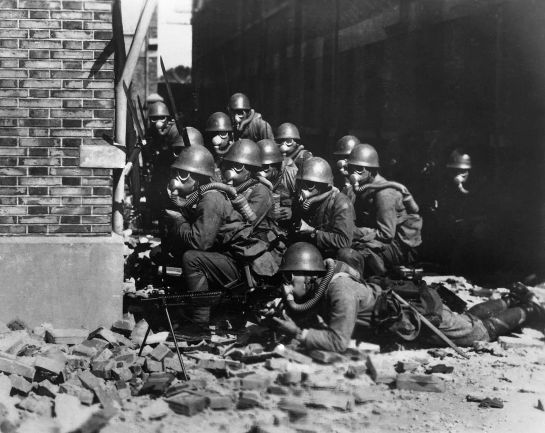 The Imperial Japanese Navy (IJN) Special Naval Landing Forces troops in gas masks prepare for an advance in the rubble of Shanghai, China, 1937. [1080×859]