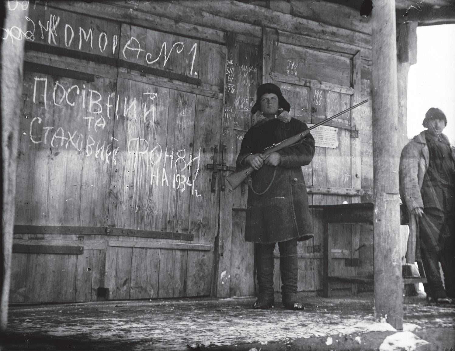 Soldier guarding confiscated grain from Ukrainian peasants, Kharkiv 1933.[1496×1155]