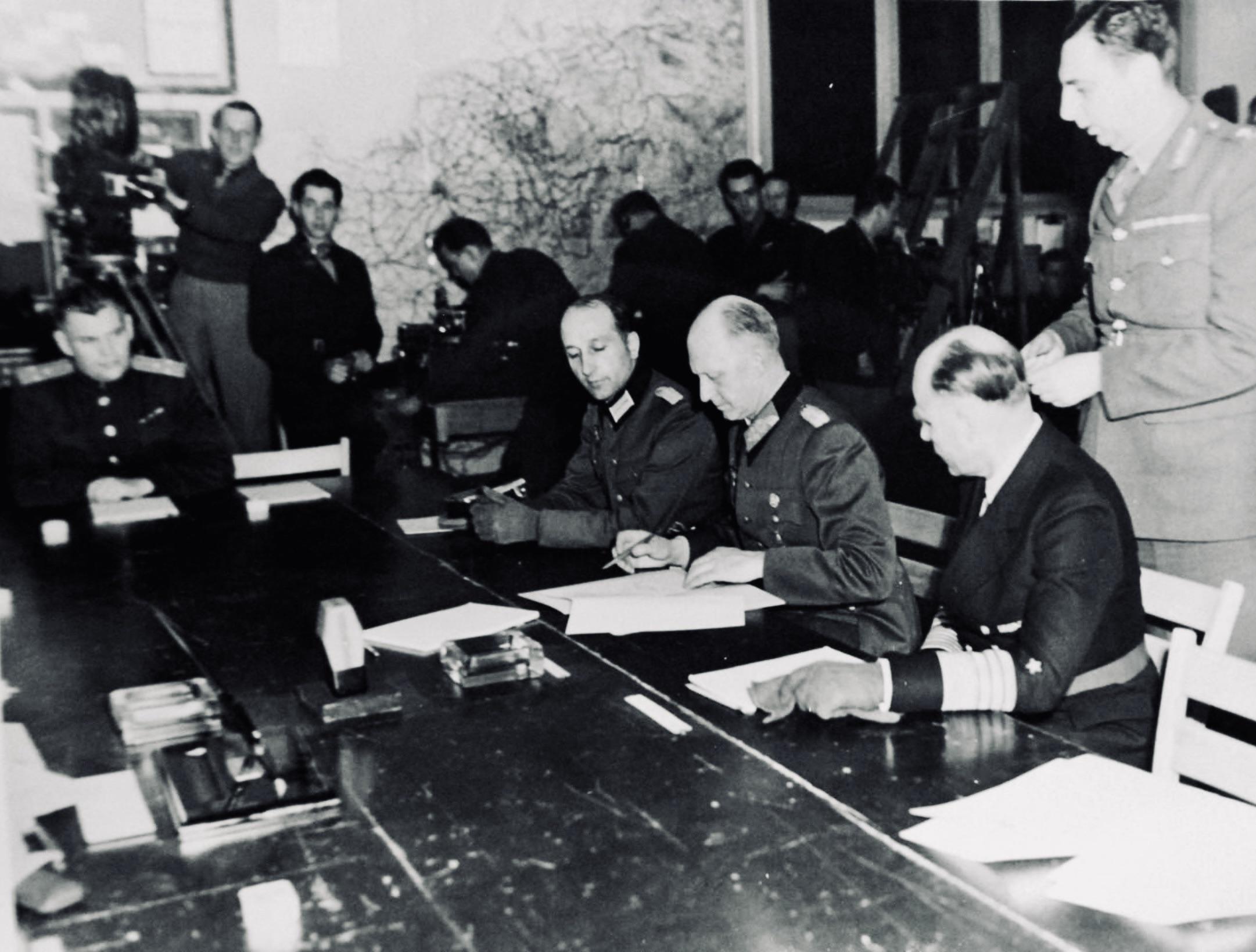 Photograph of German representatives signing the unconditional surrender of Nazi Germany in Reims, France, May 7, 1945 [1400 × 1050]