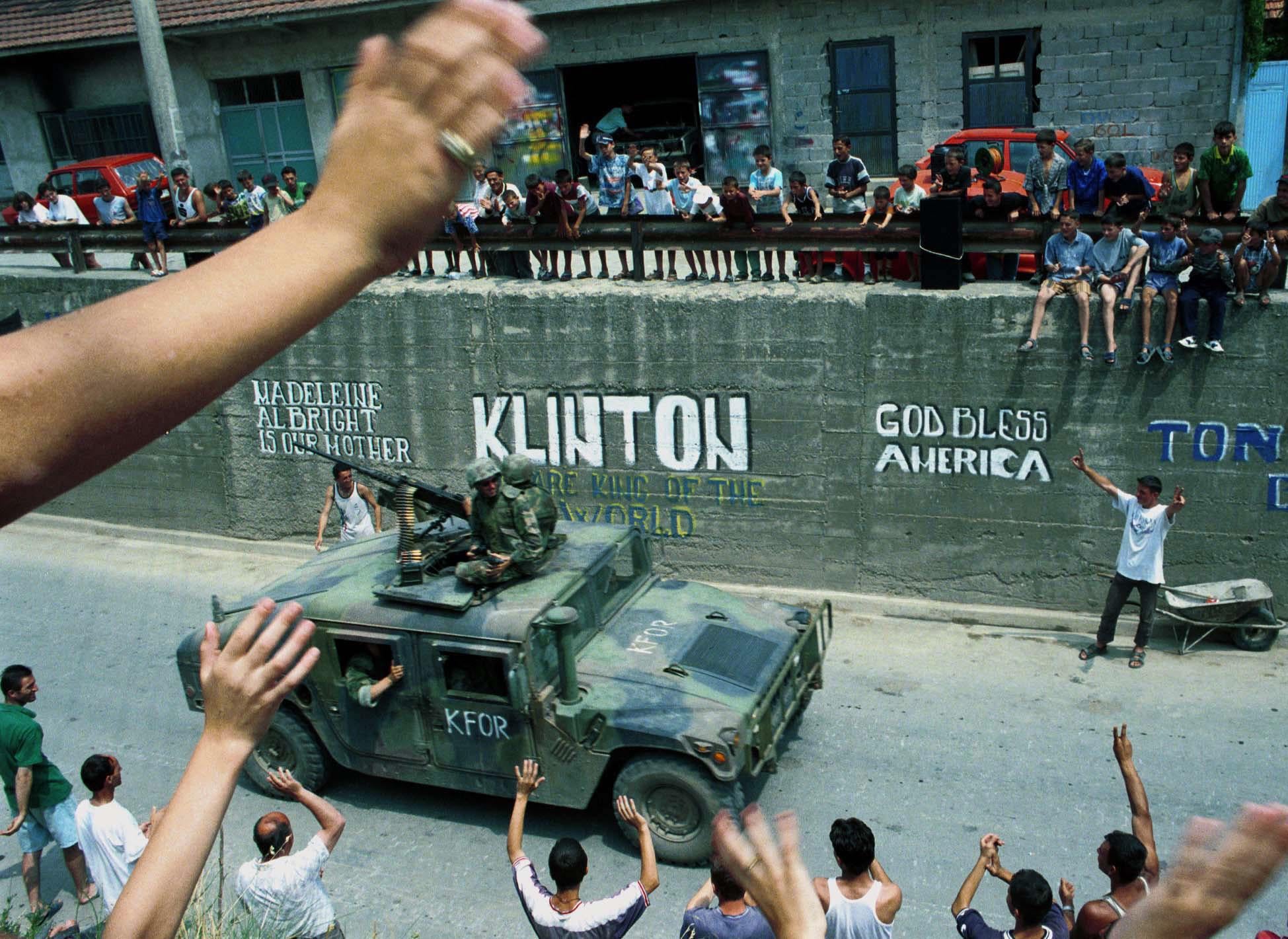Ethnic Albanians greeting American NATO troops as they arrive in Gnjilane during the Kosovo War. (1999) [1949×1421]