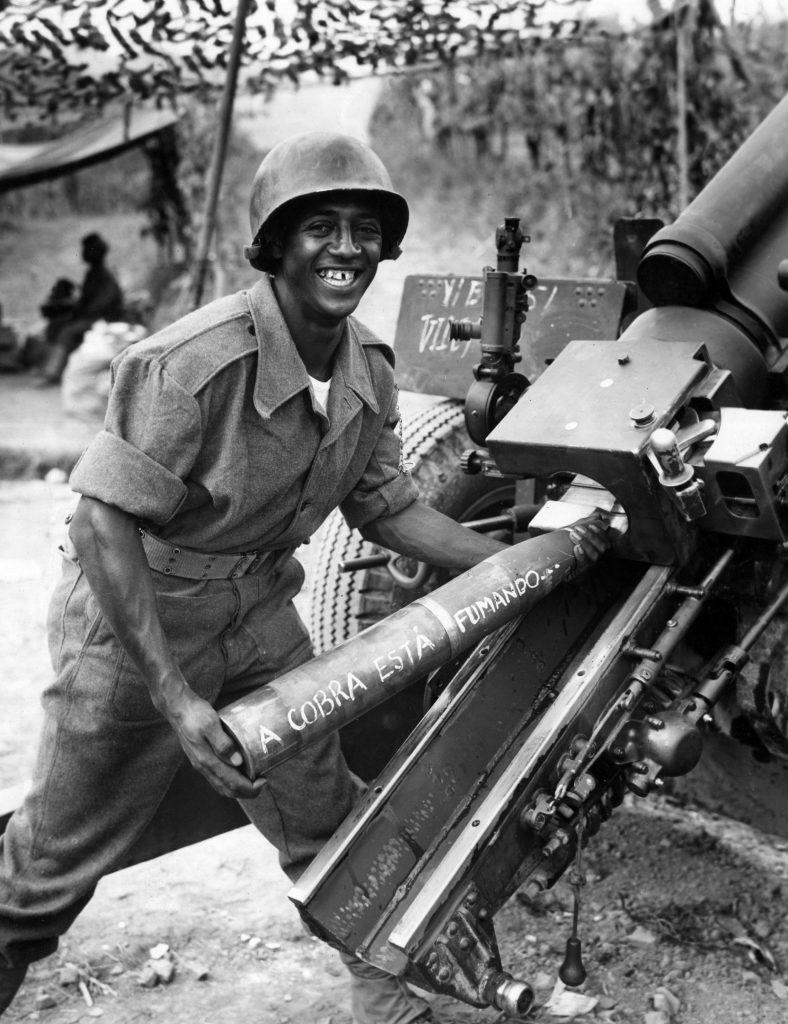 Brazilian soldier in Southern Italy battling the nazis, 1944. Written in the artillery shell is the quote “the snake is smoking”, a symbol of the Brazilian Expeditionary Forces adopted in response to critics who said “it was more likely for a snake to smoke, than to Brazil to join the war”[788×1024]