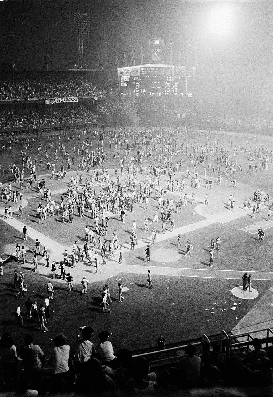 Fans storming the field during Disco Demolition Night at Comiskey Park, Chicago, Illinois, July 12, 1979 [960×1392]