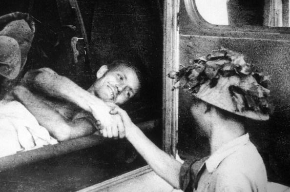 Viet Minh soldier shakes the hand of a wounded French prisoner of war after the battle of Dien Bien Phu, May, 1954. [594 × 394]