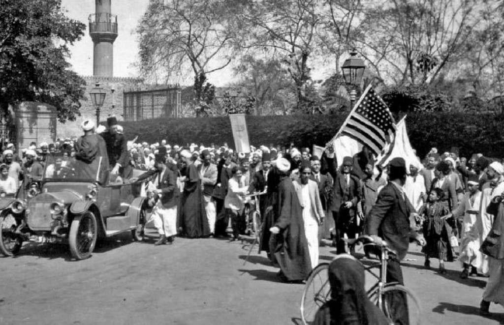 1919 Egyptian Revolution: An Egyptian Protester Raising the American Flag (1919) [1024×661]