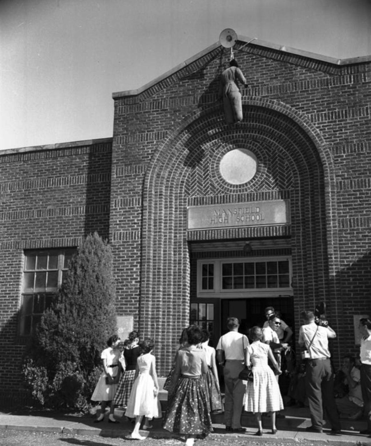 An effigy of a lynched Black man hanging above the entrance to Mansfield High School in Texas on August 30, 1956[1284X1541].