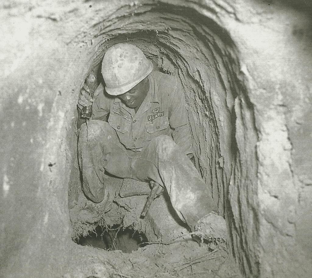 A US “tunnel rat” explores a hole between floors of a Viet Cong tunnel system, Vietnam, 1968. [1024×913]