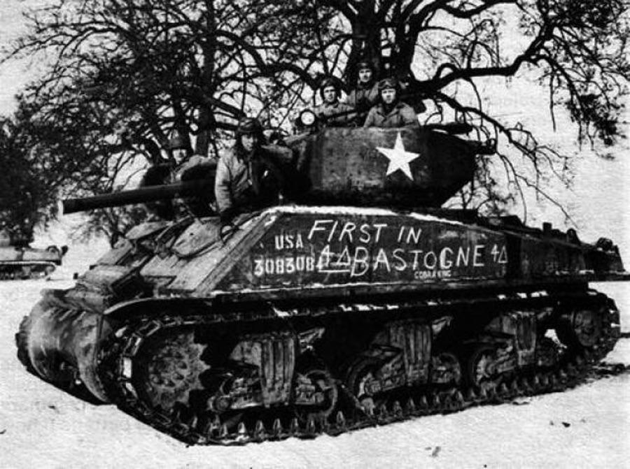 The ‘Cobra King’ crew, 1st Lt. Charles Boggess, Cpl. Milton Dickerman and Pvts. James G. Murphy, Hubert S. Smith and Harold Hafner, posing for a celebratory photo in Bastogne, Belgium shortly after the tankers led the armor and infantry column that liberated the city. Dec 1944. [900×671]