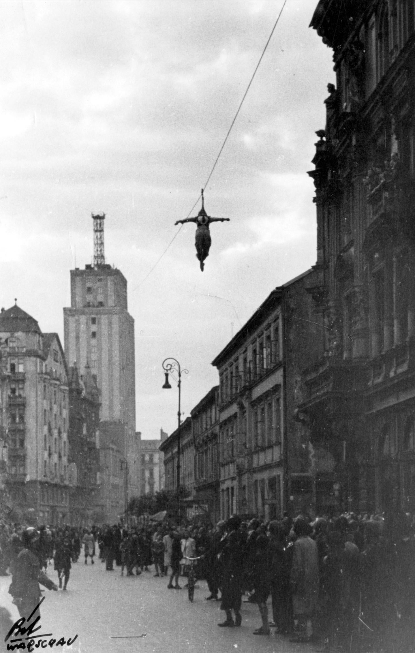 People watching circus performer Irmgard Mayer suspended over Szpitalna Street, Warsaw, Occupied Poland, 1942. [1439×2264]