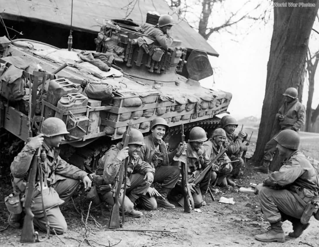 81 years ago today, American GIs rest behind an M5 Stuart tank near Germersheim, Germany. (March 25, 1945) [1100×851]