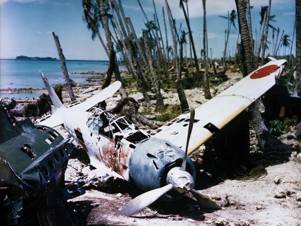 Wreck of a Japanese Mitsubishi A6M3 Zero (T2-157) fighter aircraft – from the Imperial Japanese Navy Air Service – at Munda Airfield, New Georgia, Solomon Islands), c. September 1943. [1050 x 788]