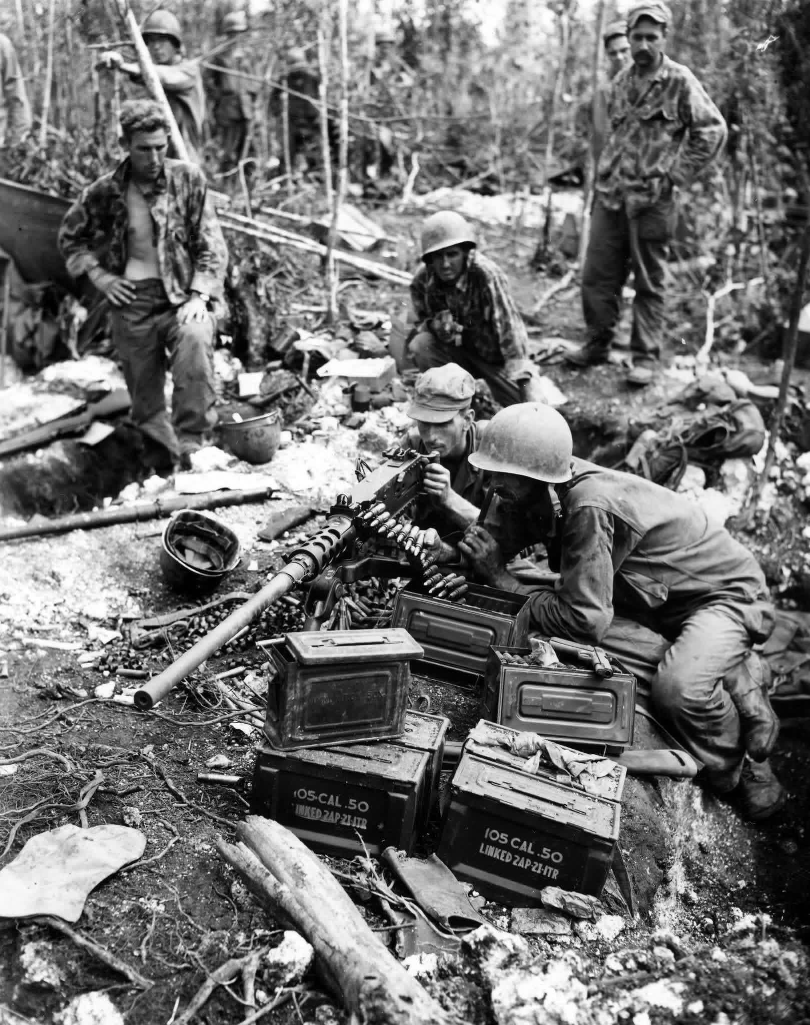 Pvt. Andy Hamilton, Vincentown, New Jersey; Pvt. Chester Klovas, Chicago, Ill.; Pfc. Harry Reynolds, Loogoote, Ind.; gun crew of the .50 caliber machine gun is credited with half of 109 Japanese slain on Biak Island, Dutch New Guinea on 22 June 1944. [1619×2048]