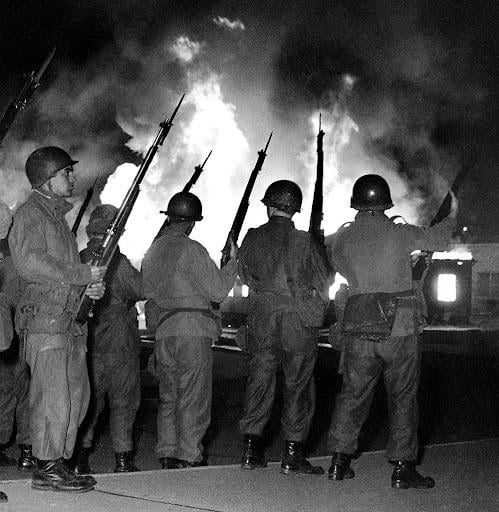 National Guardsmen standing outside the Kent State ROTC building, which had been set ablaze by anti-war protesters earlier that day. Firefighters were pelted with rocks upon attempting to extinguish the flames. May 2nd, 1970 [499×512]